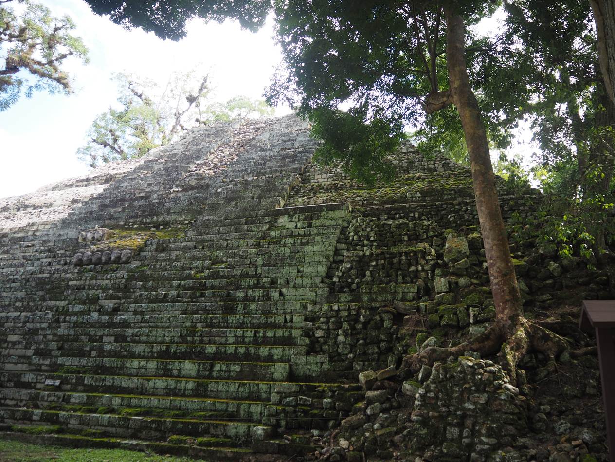 A low angle view of a stone pyramid

AI-generated content may be incorrect.
